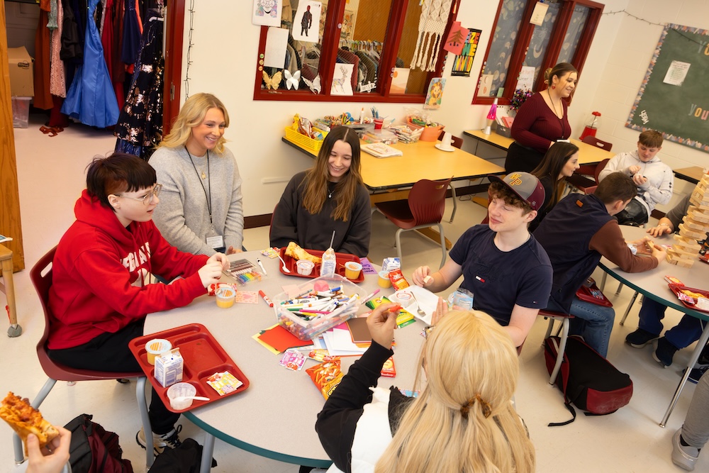 Expanding mental health services and making them available in schools is a key initiative of the UACS model at Whitney Point. Social work intern Avery Burnsworth, second from left, meets with students at Whitney Point High School.