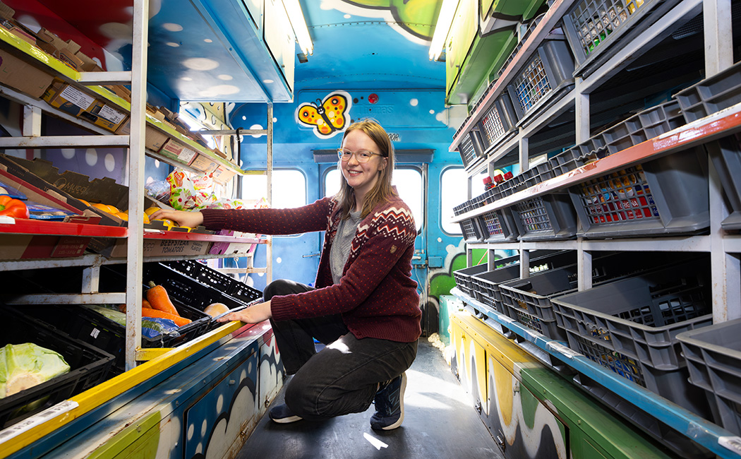 Eden Lowinger, a Master of Social Work student in the College of Community and Public Affairs, interns with the Greater Good Grocery in the City of Binghamton, pictured here in February 2025.