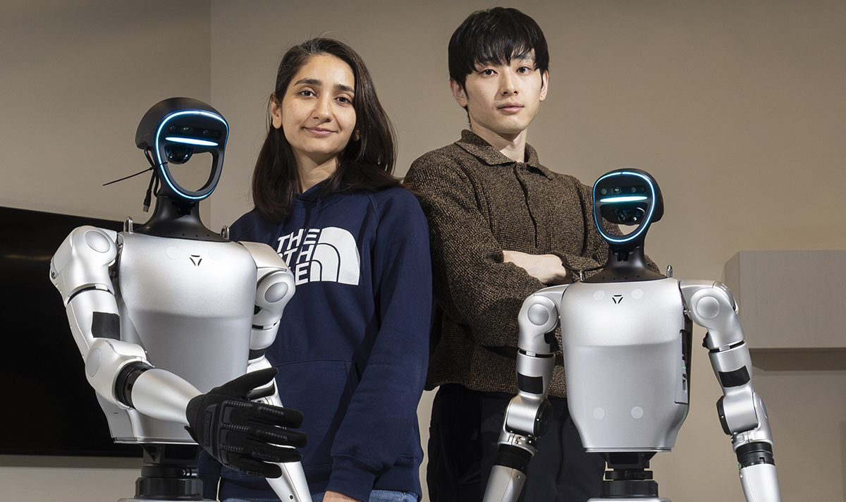 PhD students Zainab Altaweel, left, and Yohei Hayamizu work in Associate Professor Shiqi Zhang's lab at Watson College's School of Computing, where they are learning how to control two new humanoid robots.