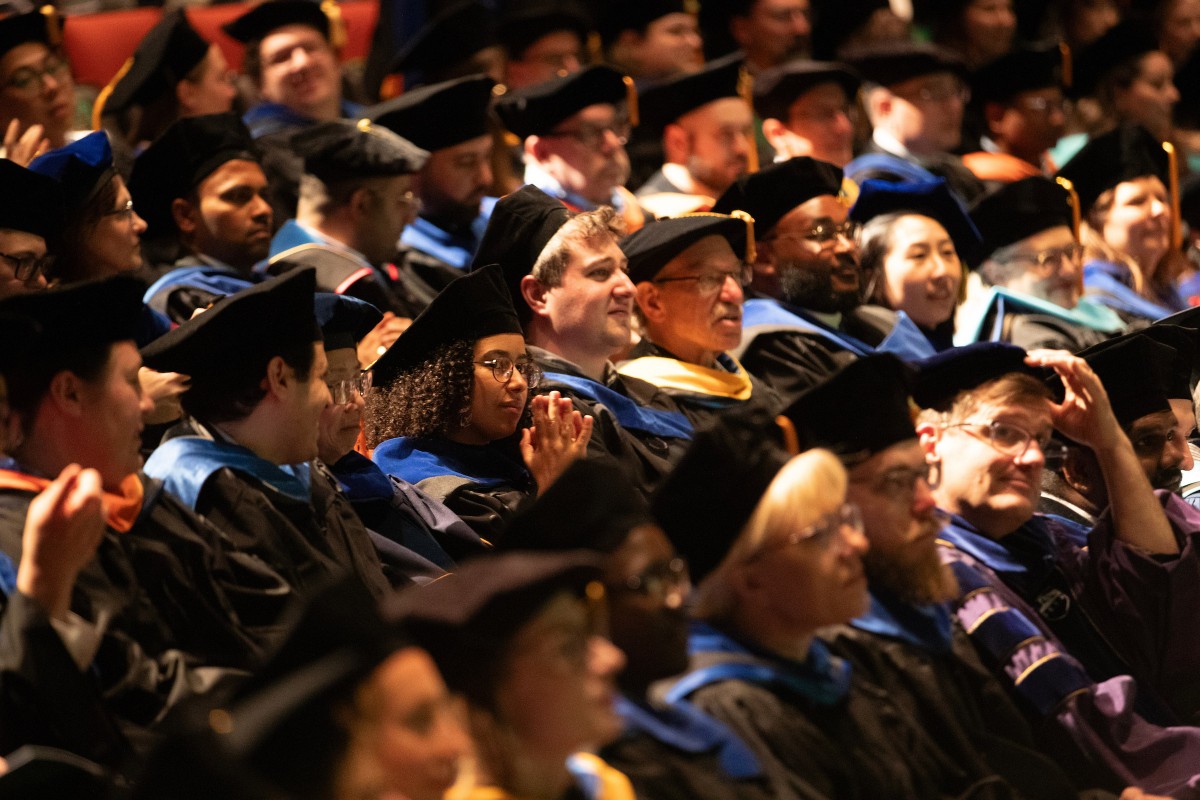Doctoral degree recipients and professors sit in the Osterhout Concert Theater during the doctoral hooding ceremony on May 15, 2025.