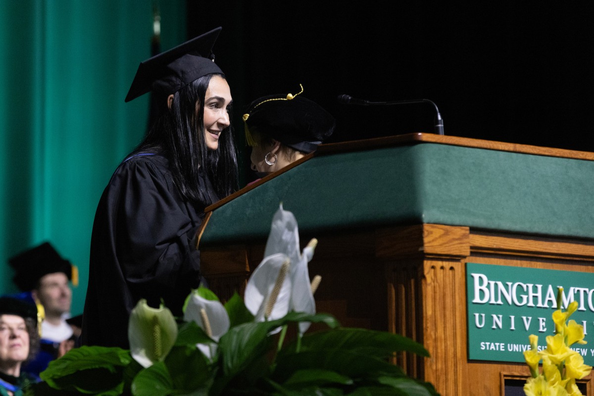 Jennifer Flanz '98, showrunner for Comedy Central's The Daily Show, speaks during the first Harpur College Commencement ceremony on May 17, 2025.