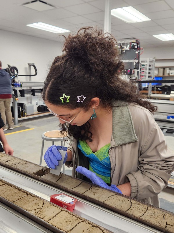 Sofia Corsico-Sánchez conducts research on a sediment core in College Station, Texas, as part of the OCEAN CORE Academy summer research intensive.