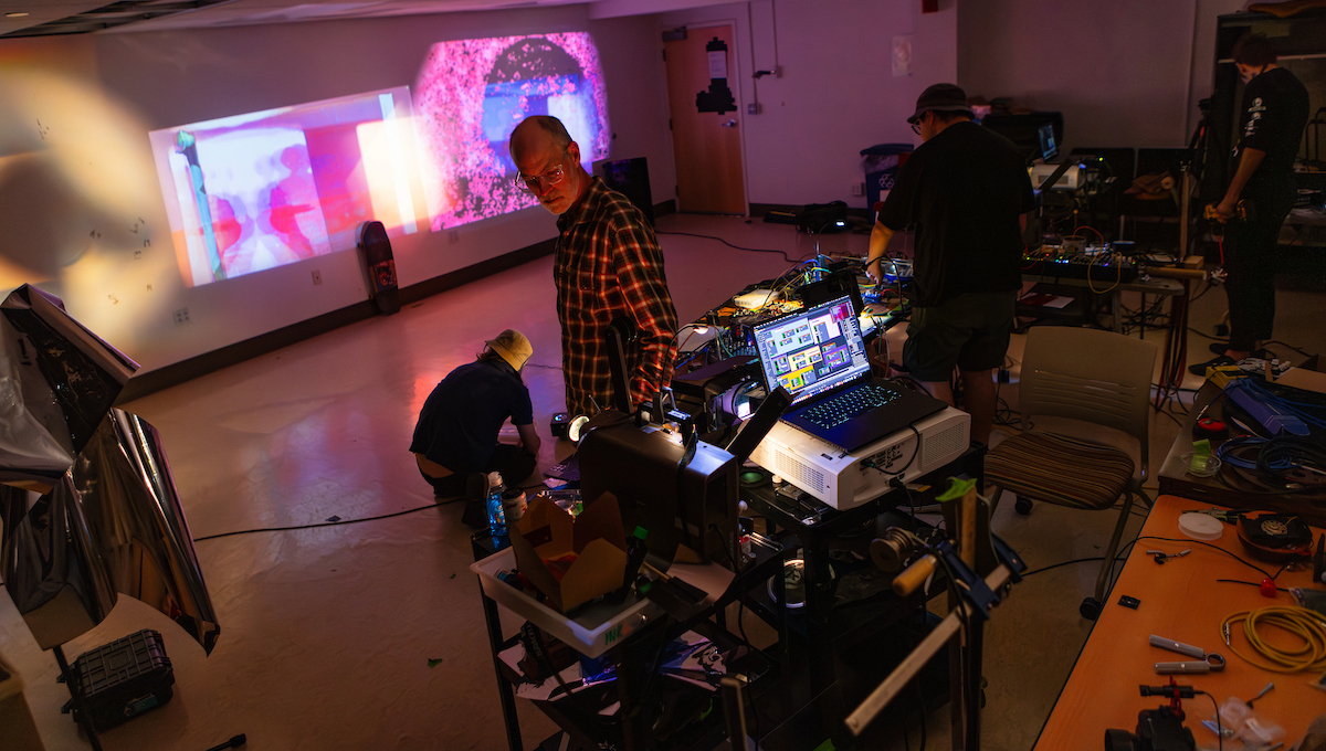 Associate Professor and Cinema Department Chair Monteith McCollum, center, collaborated with his students for a project that integrated film and skateboarding.