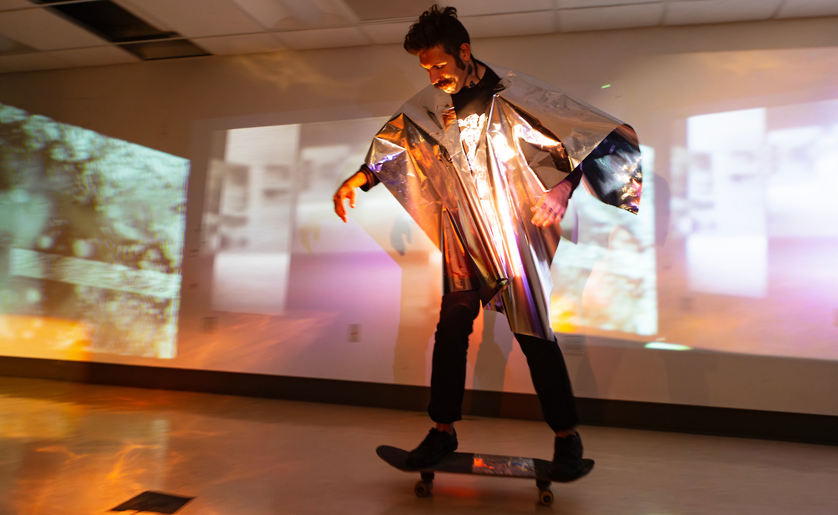 Cinema graduate student Benjamin Stone rehearses a project integrating film and skateboarding at Binghamton University's Lecture Hall. He and two other students performed the piece in Croatia along with Associate Professor and Chair Monteith McCollum.
