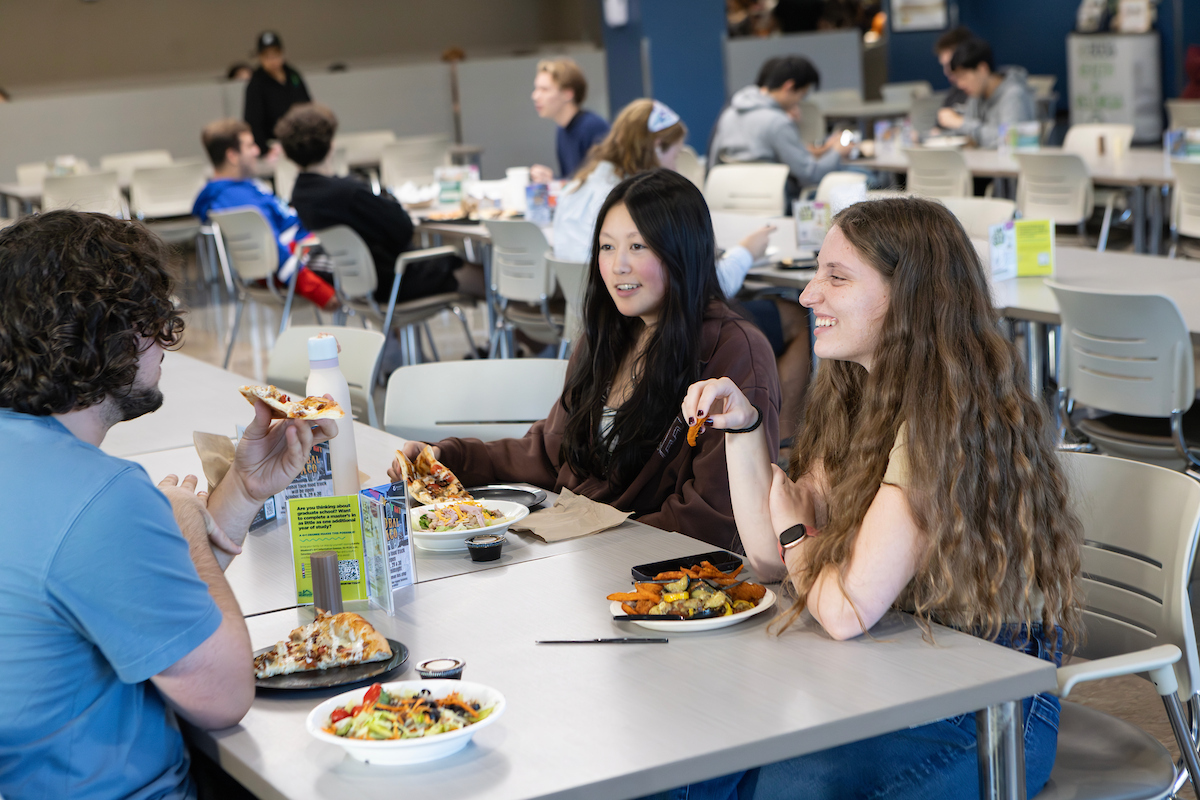 Undergraduate Raya Sitman eats dinner with friends at the Chenango Champlain Collegiate Center.
