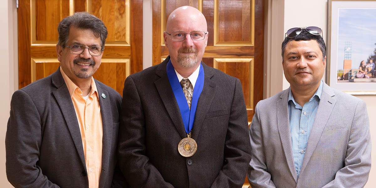 Douglas Summerville, center, was named a SUNY distinguished teaching professor in 2025. With him at the celebration in October are Watson College Dean Atul Kelkar, left, and Indranil Bhattacharya, professor and chair of the Department of Electrical and Computer Engineering.