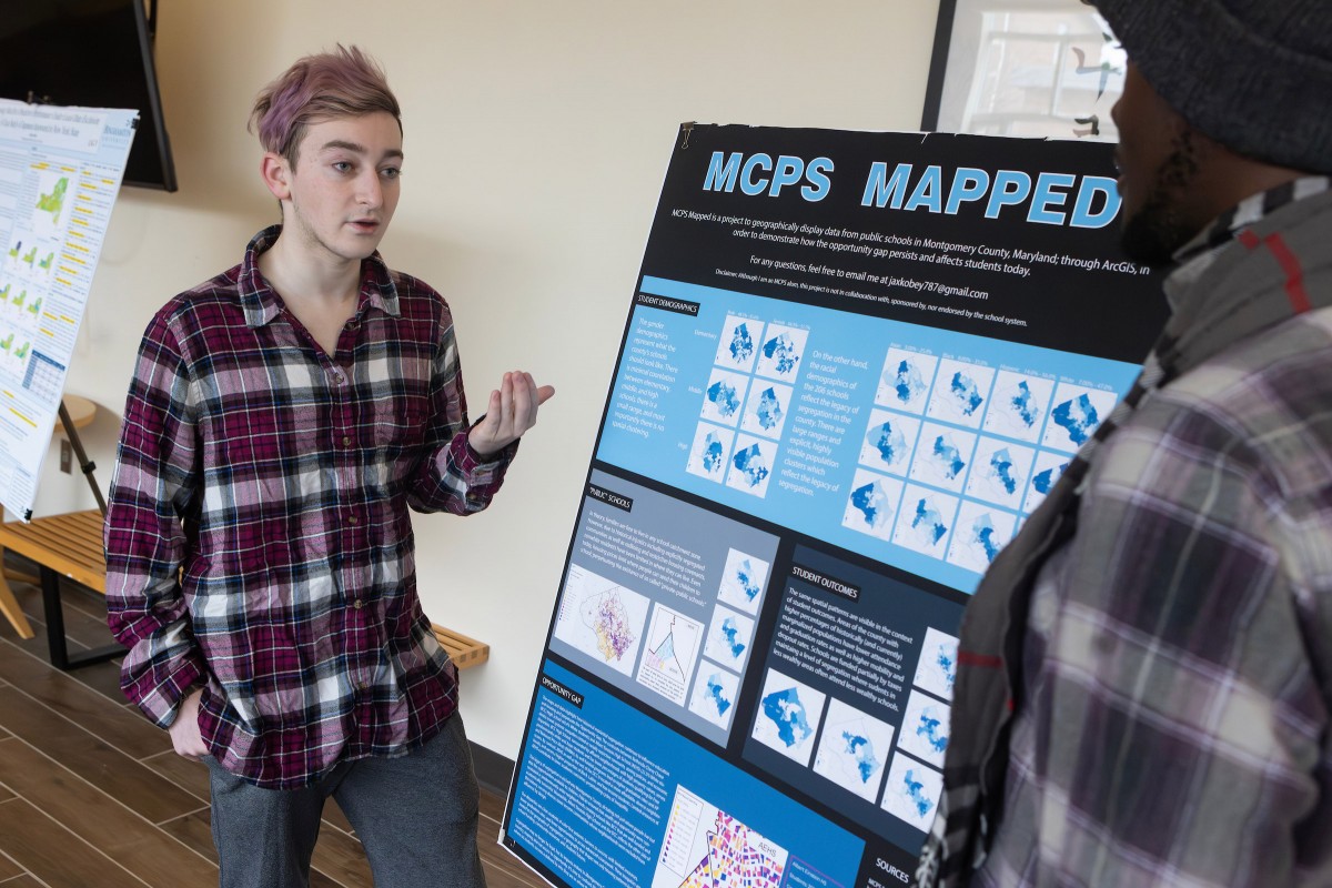 Jax Kobey, a sophomore majoring in geography and urban planning, discusses a map he created that shows and racial disparities in schools located in Montgomery County, Maryland.