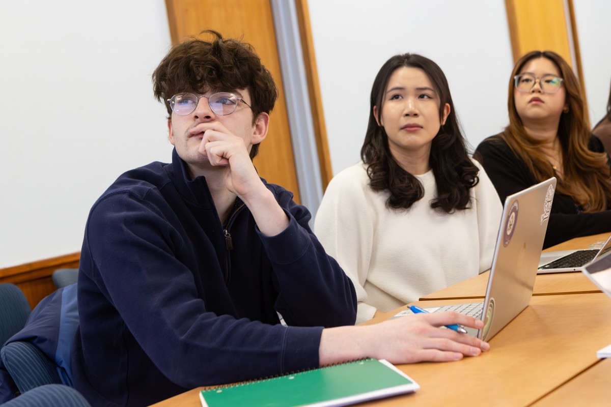 From left, students Trevor Grimes, Cynthia Chen and Kristen Li listen as Associate Professor of History Wendy Wall discusses an ongoing research project into racial covenants in Broome County.