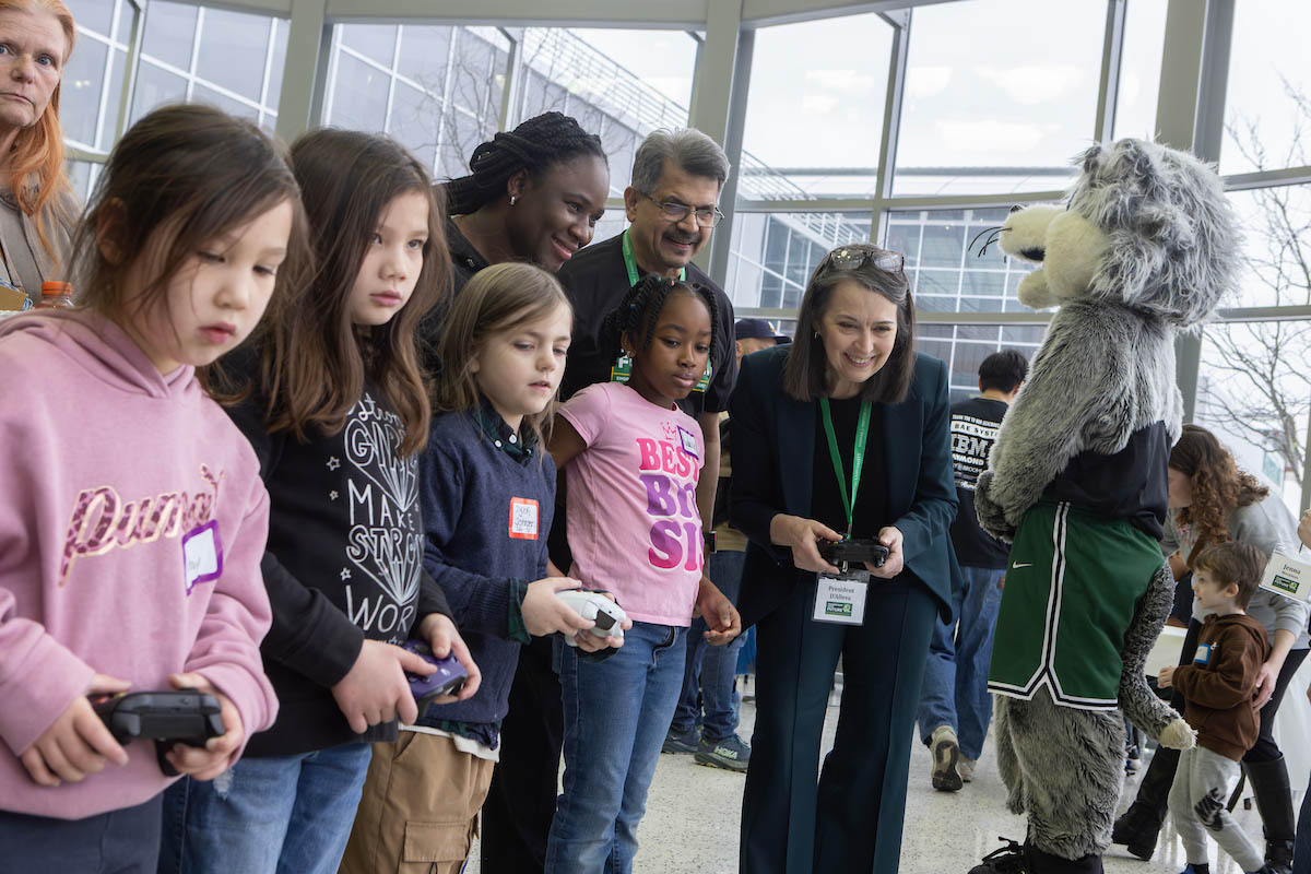 Watson College Dean Atul Kelkar and Binghamton University President Anne D'Alleva join children in an activity at Community Day 2025, part of Engineers Week.
