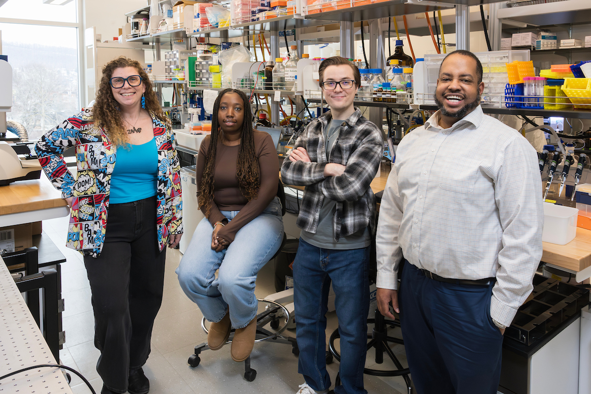 Tracy Brooks, the chair and associate professor of pharmaceutical sciences, Nelly Michura, a junior biology and global public health double major on a pre-med track, Steven Mckay, a fourth-year doctoral student who does both synthesis in the Davis Lab and testing in the Brooks Lab, and Tony Davis, an assistant professor of pharmaceutical sciences, pose at the Davis Lab in the Pharmacy Building in Johnson City, New York.