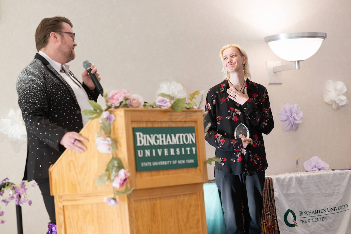 Associate Director Nick Martin presents the Activism Award to Mims Harrington, a double major in Social Work and Women, Gender, and Sexuality Studies.