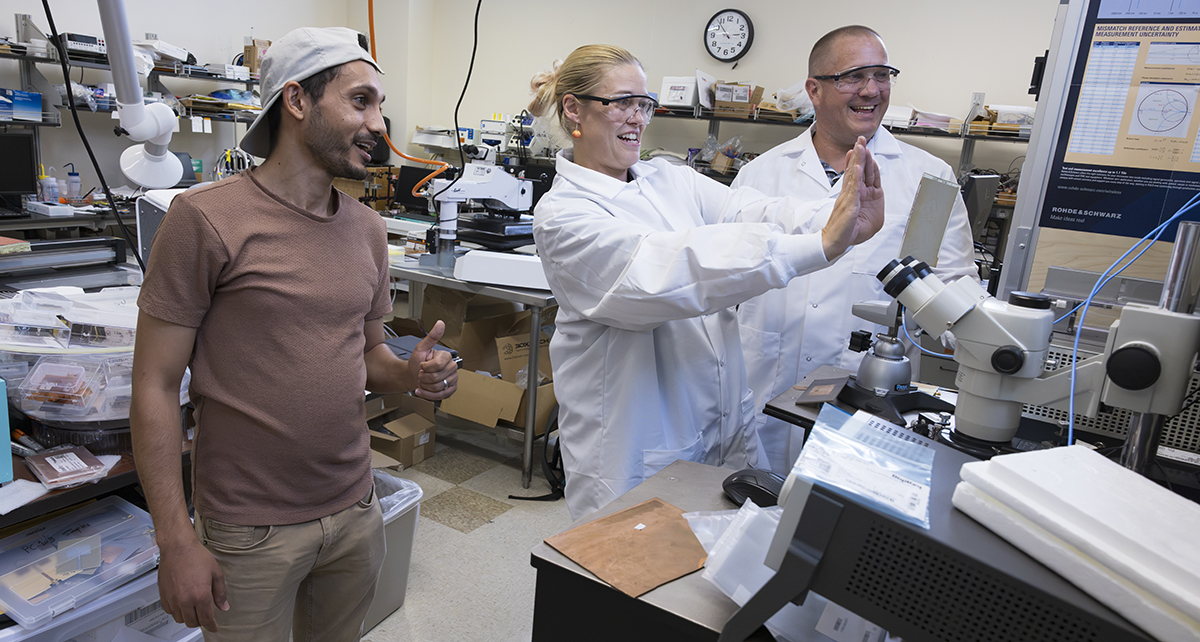 Teachers Casey Baumlin and Brian Kinney work on flexible electronics in Distinguished Professor Mark Poliks' lab with Waleed Al-Shaibani, left, a PhD candidate in the School of Systems Science and Industrial Engineering. Baumlin and Kinney were part of the Research Experiences for Teachers program.