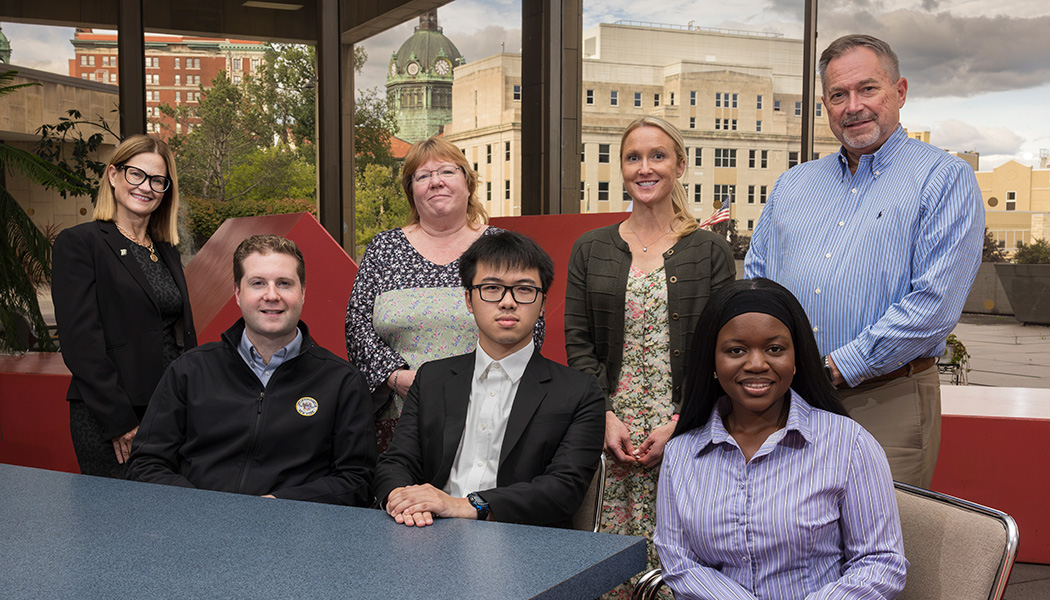 A team of Binghamton University students found ways for the City of Binghamton to upgrade its water billing system to improve efficiency and reduce municipal costs. Lombe Mwambwa and Ethan Tong (front right) are pictured at Binghamton City Hall with Mayor Jared Kraham. They're joined by Kelli Smith, the University's assistant vice president for student success, Cindy Mattingly, deputy city treasurer, Amber Coyne, employer relations manager in healthcare and science industries at the University's Fleishman Career Center, and Lawrence Harris, city treasurer.