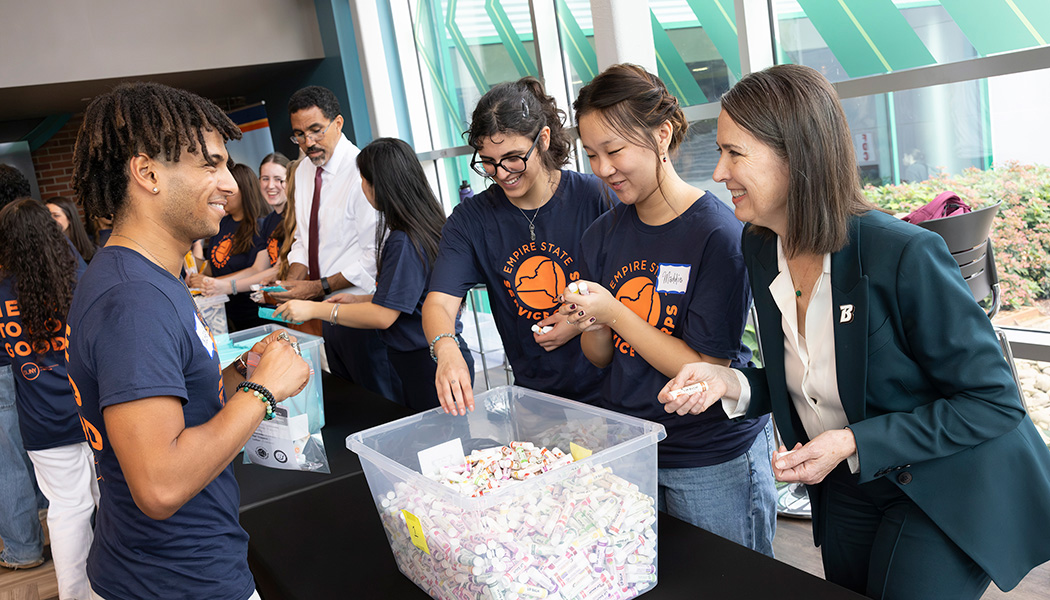 Binghamton University President Anne D'Alleva works alongside student volunteers with the Empire State Service Corps to assemble hygiene kits for local schools and nonprofits on Wednesday, Sept. 9, 2026.