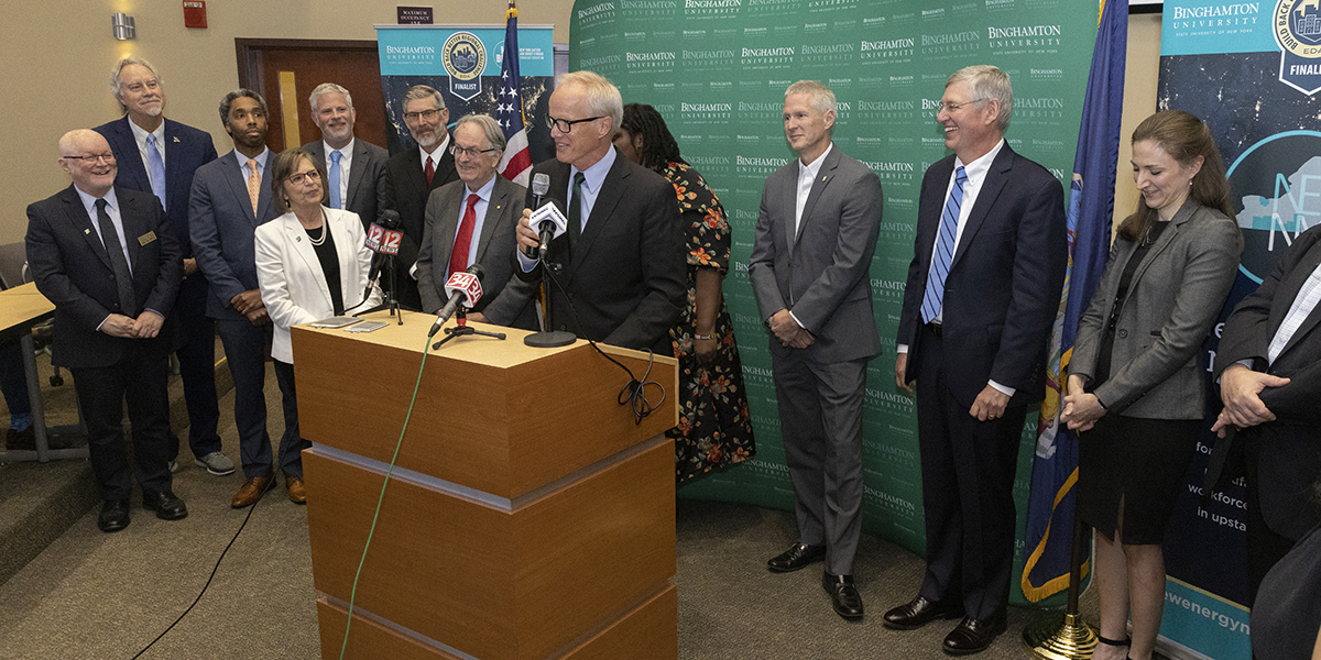 President Harvey Stenger, at the podium, is flanked by members of the New Energy New York coalition at the news conference held following President Joe Biden's announcement that the Binghamton University-led coalition's proposal was one of only 21 selected for American Rescue Act Build Back Better Challenge funding and will receive $63.7 million.