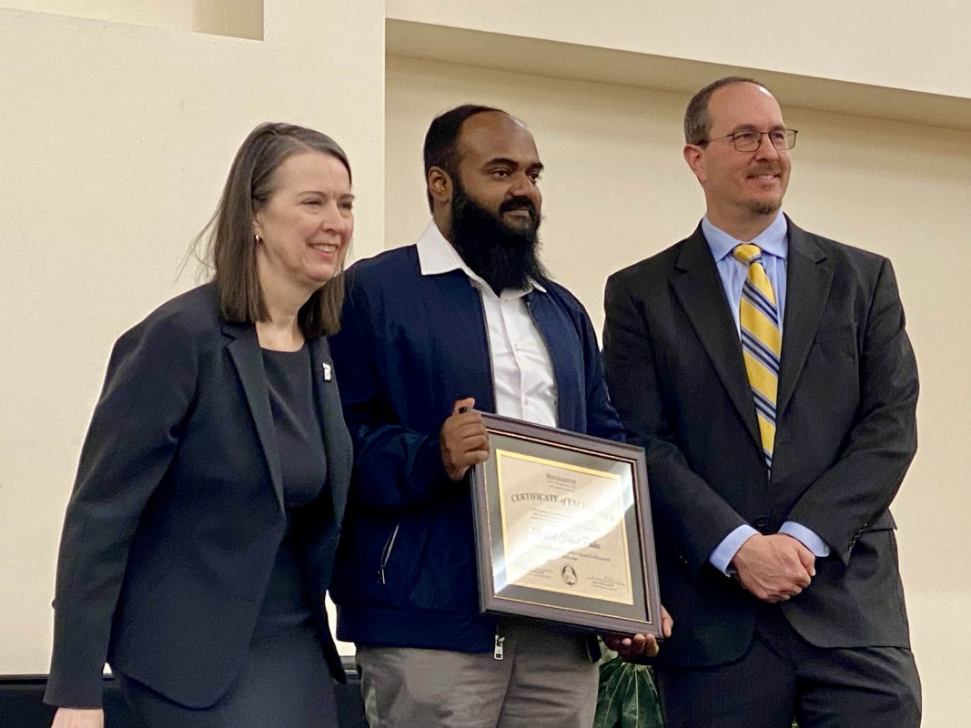 Abdullah Faisal Pasha, a doctoral student in Chemistry, receives the Award for Excellence in Research from Binghamton University President Anne D'Alleva and Dean of the Graduate School Terrence Deak.