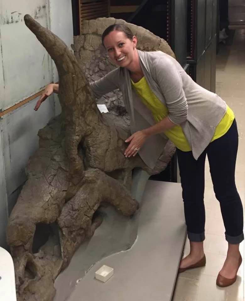 Adriane Lam poses with the holotype -- the first fossil discovered and named -- of Triceratops at the Smithsonian Museum of Natural History.