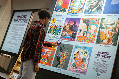 Several portraits are displayed in the “Imagine the Future” exhibit in Bartle Library. Using a free phone app, the images animate and share a message pertaining to their theme.