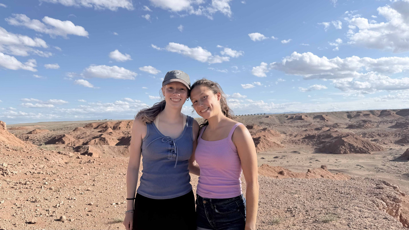 Ariel Esposito and Matilda Fillion pose in the Gobi Desert.