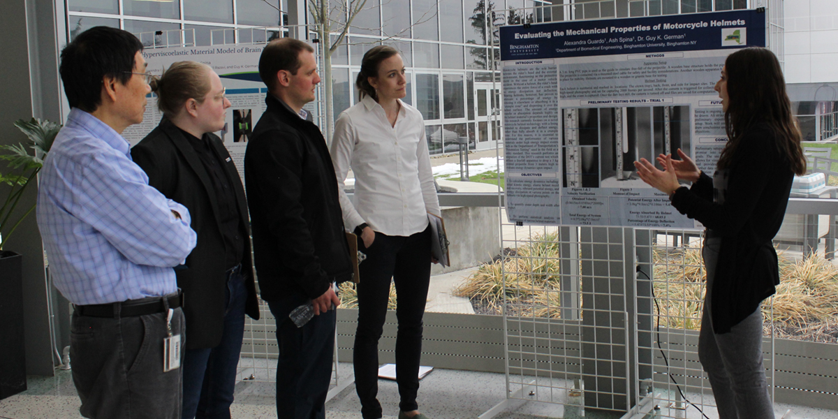 Student Alexandra Guardo, right, explains her research at the Biomedical Engineering Research Expo held in April 2022.