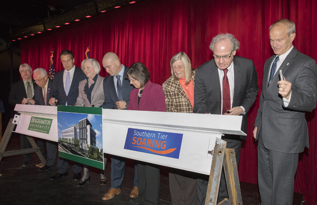 University, state and local officials sign a School of Pharmacy and Pharmaceutical Sciences beam on Nov. 15 in Johnson City. From left are: Greg Deemie, Johnson City mayor; Assemblyman Clifford Crouch; Gov. Andrew Cuomo; Gloria Meredith, dean of the School of Pharmacy and Pharmaceutical Sciences; state Sen. Fred Akshar, Assemblywoman Donna Lupardo; Rose Sotak, town of Union supervisor; Howard Zemsky, president and CEO of Empire State Development; and Binghamton University President Harvey Stenger.