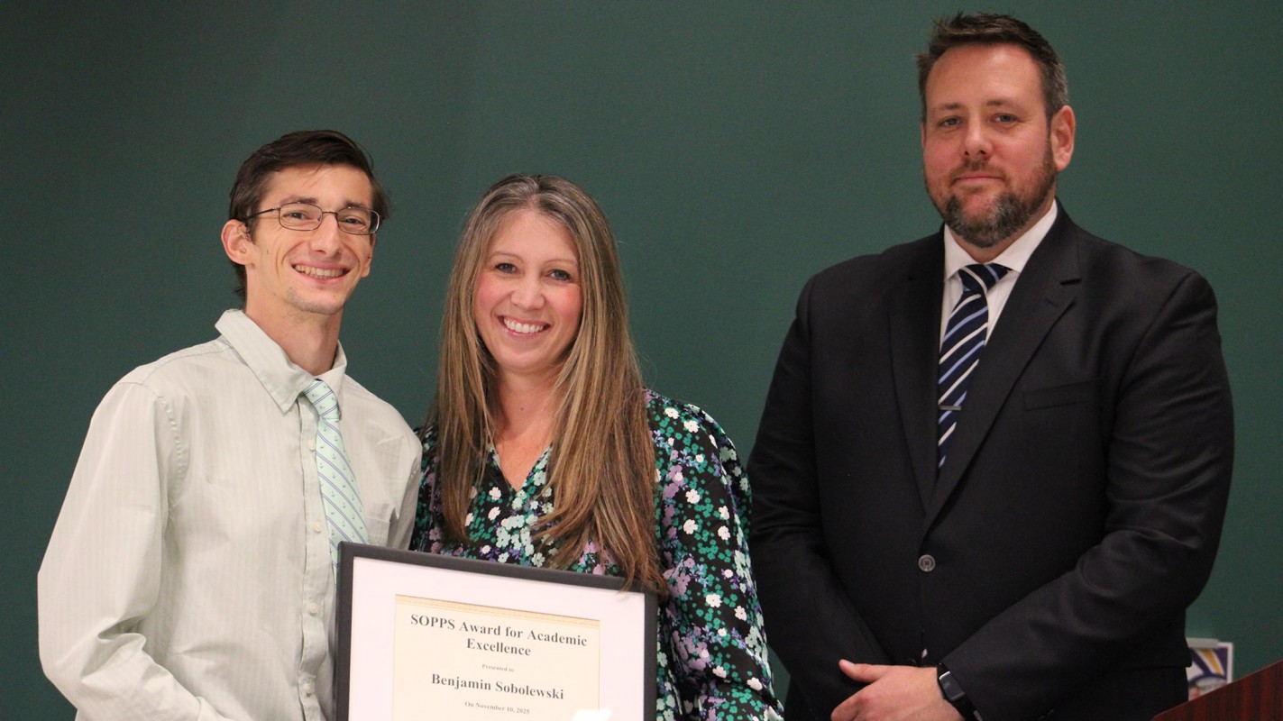Second-year pharmacy student Benjamin Sobolewski accepting his Class of 2028 Award for Academic Excellence from Student Success Advisor Erica Folli and Director of Student Affairs James 