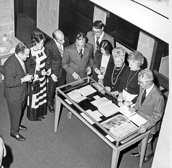 Left: CEMERS founder Aldo Bernardo, left, and other participants look at a book exhibition at the “Islam and the Medieval West” conference in May 1975. Right: Rosmarie Morewedge, associate professor of German at Binghamton University, and Franz Bauml of UCLA.