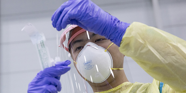 Pharmacy student Brian Kam, seen here in full PPE, was one of many PharmD students who volunteered to assist with testing of incoming residential students for COVID-19 in fall 2020.