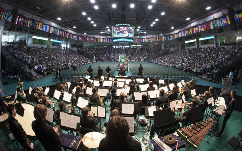 Daniel Fabricius conducts a group of Binghamton University student musicians during a Harpur College commencement ceremony in 2017.