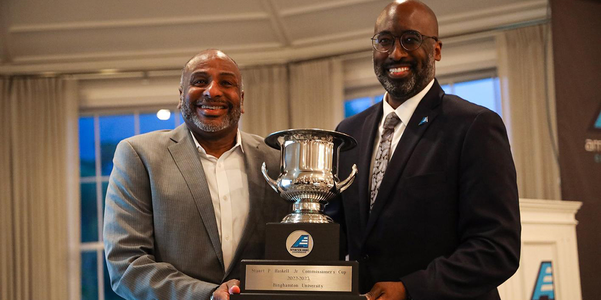 Binghamton Bearcats Director of Athletics Eugene Marshall, Jr. accepts the America East Stuart P. Haskell, Jr. Commissioner's Cup for overall excellence from America East Commissioner Brad Walker.