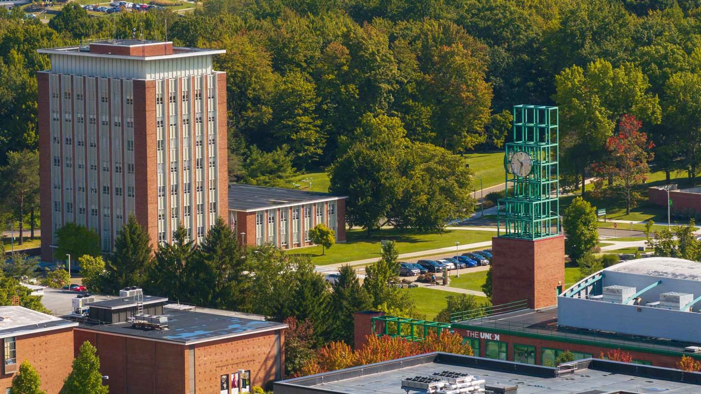 Binghamton University's Vestal campus, highlighting the Couper Administration Building on the left and the clock tower on the right.