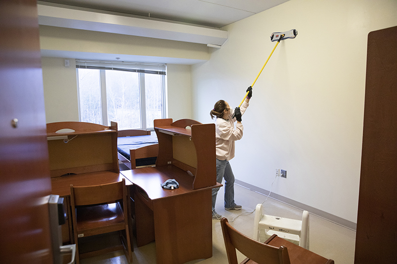 Kim Maus of Physical Facilities cleans a room on the fifth floor of Johnson Hall at Dickinson Community.