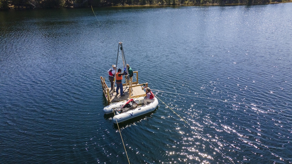 Scientists lower a hollow metal tube (a freeze core) filled with dry ice and ethanol to collect sediment samples from the lake bottom. Like rings of a tree, each layer of sediment in Crawford Lake can be dated to a specific year.