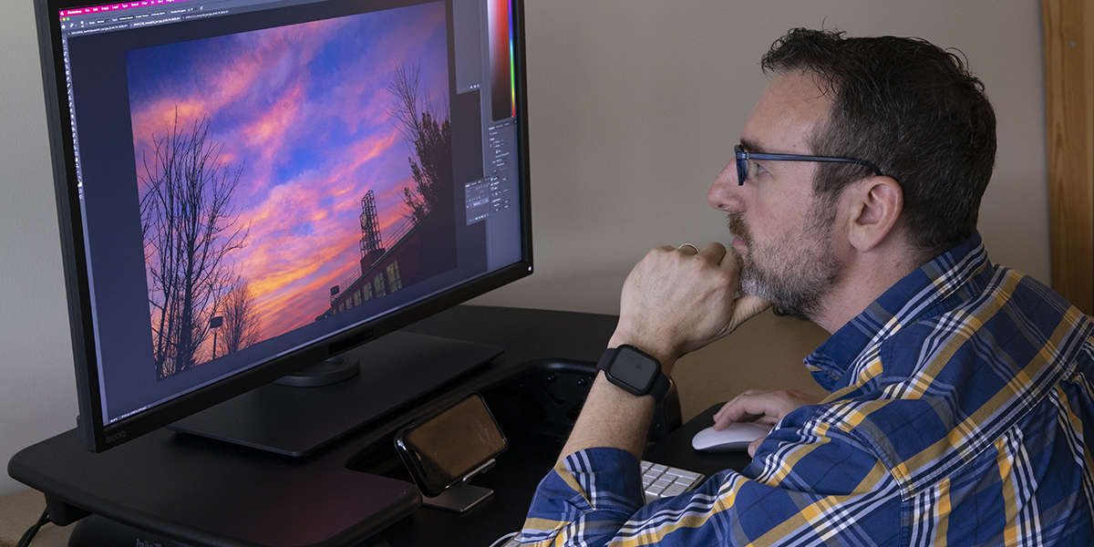 Jonathan Cohen edits one of the thousands of photos he has taken for the University.