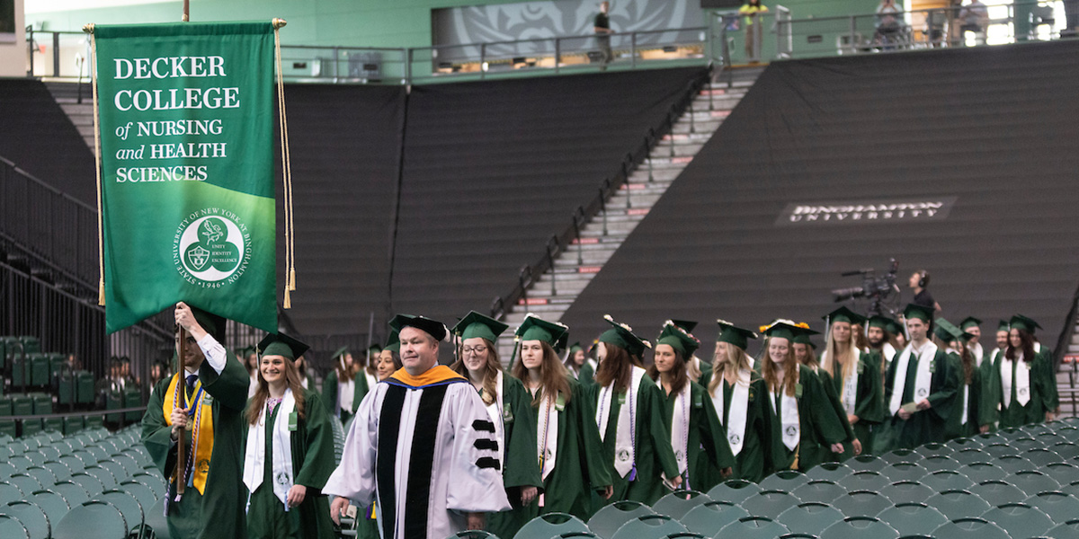 Binghamton University’s Decker College of Nursing and Health Sciences conferred almost 300 bachelor's, master's and doctoral degrees at Commencement 2023. Here, nursing students proceed into the Events Center, led by Clinical Instructor Brian Coveleskie '15, who served as school marshal at the event.