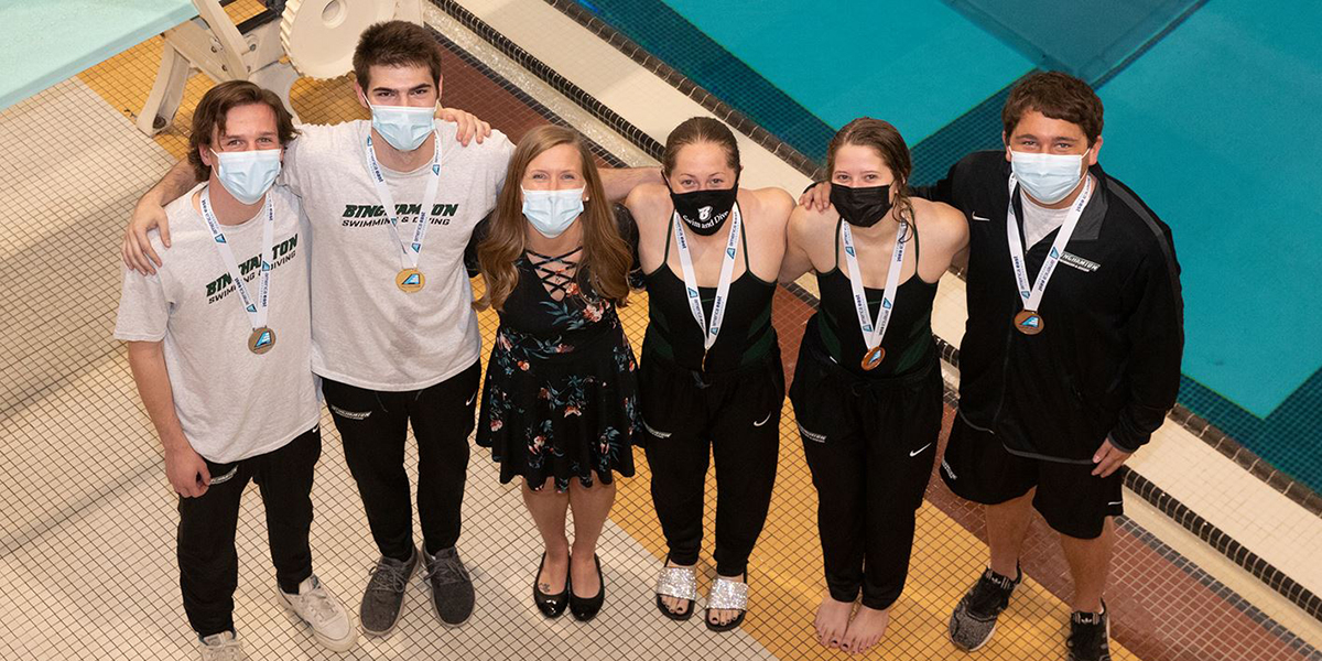 David Walters, second from left, and Sophia Howard, third from right, took first place in both 1- and 3-meter events at the America East Diving Championships, April 17-18. Erik Temple, left, and Ryan Cohn also medaled in both events, marking the first time in the team's history to sweep all medalist honors at an AE championship. Lindsey Weissman, second from right, took third in the 3-meter event. Head diving coach Heather Colby is third from left.