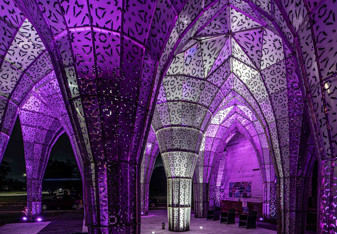 American Riad, a public sculpture in Detroit, is illuminated at night.