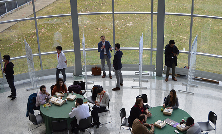 Students presenting and discussing their posters as part of the conference.