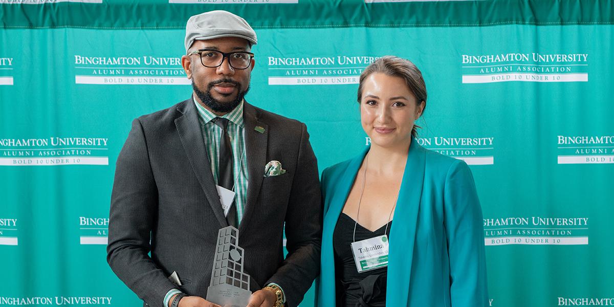 Louis R. Alerte ’10, MS ’13 receives a BOLD 10 Under 10 award from Tahmina Igamberdiev ’13, Alumni Association board member.