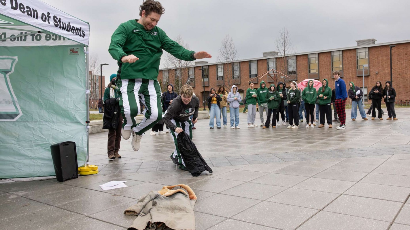 Derrick Bradford, manager of game day experience in athletics, stomped on the coat at the 2026 ceremony.