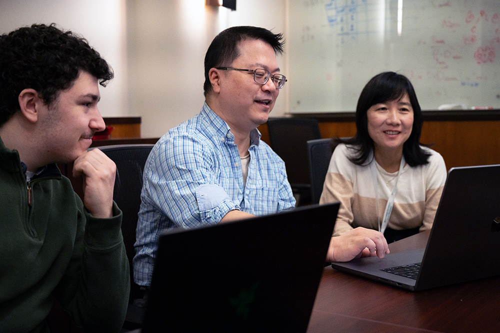 Postdoc Josh Chen, center, works on a cancer detection project with Nancy Guo, empire innovation professor, and undergraduate Stephen Barnum through Binghamton’s Excellence in Entrepreneurship and Discovery (EXCEED) program.