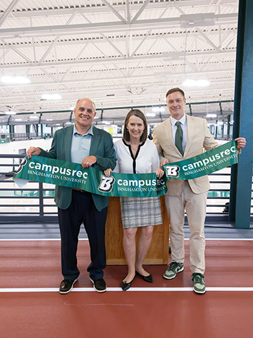 Binghamton University President Anne D'Alleva celebrates the opening of the East Gym addition with Brian Rose, vice president for student affairs, left, and Tom St. John, director of campus recreational services.