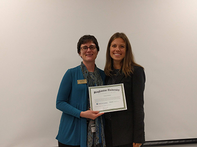 Biomedical engineering student Emma Northrup with Associate Professor Aaron Beedle from the Department of Pharmaceutical Sciences commemorating the completion of the REU.
