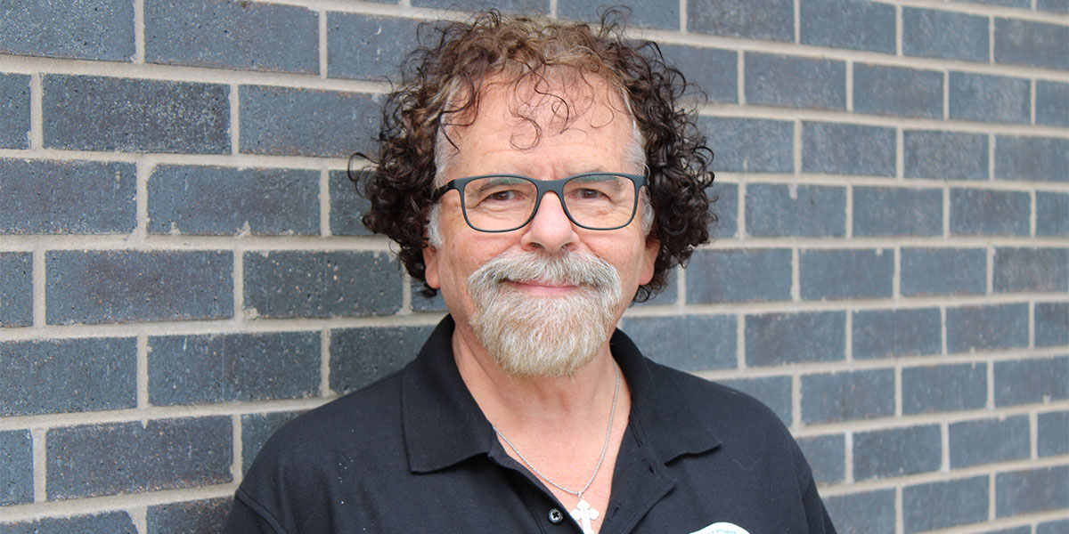 Clinical Assistant Professor Eric Richards standing outside the Binghamton University School of Pharmacy and Pharmaceutical Sciences