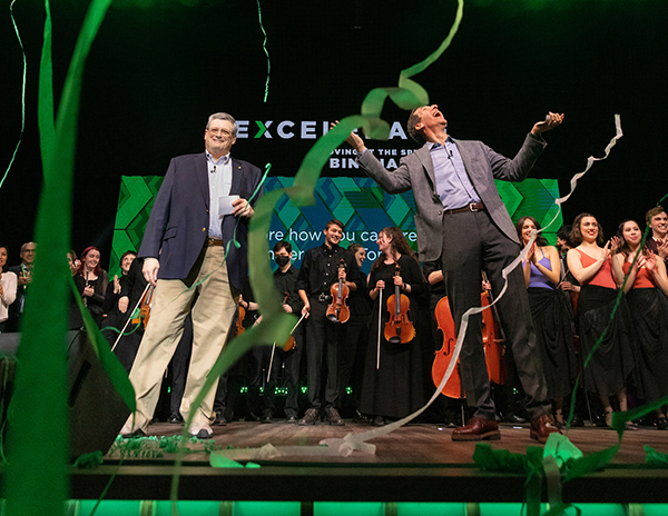 Owen Pell ’80, LLD ’11, chair of the Binghamton University Foundation Board, left, and campaign Chair Howard 
Unger ’82, LHD ’19, celebrate at the EXCELERATE launch in Watters Theater on April 9.