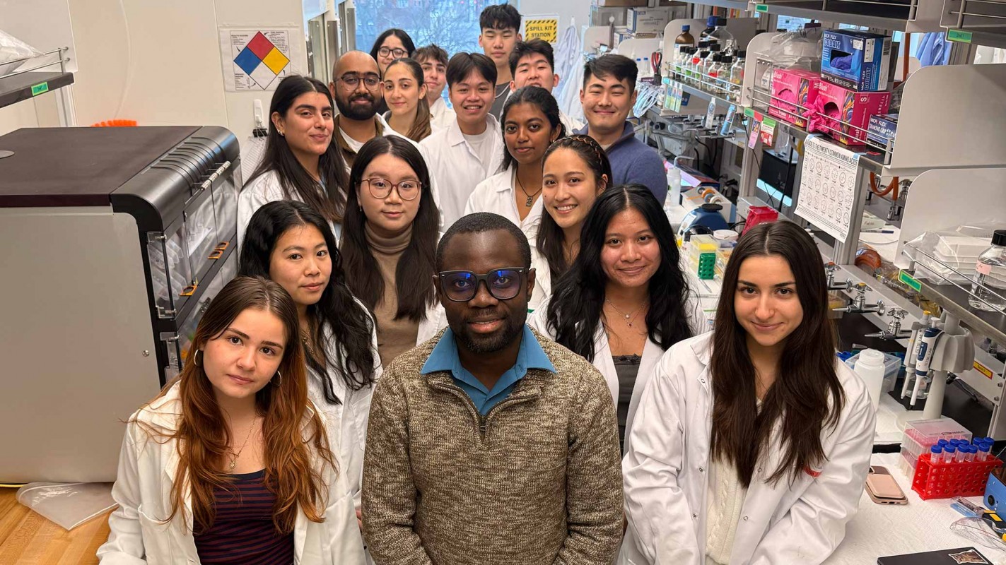Assistant Professor of Pharmaceutical Sciences John Fetse (center front) with all of the students he is mentoring in his lab.