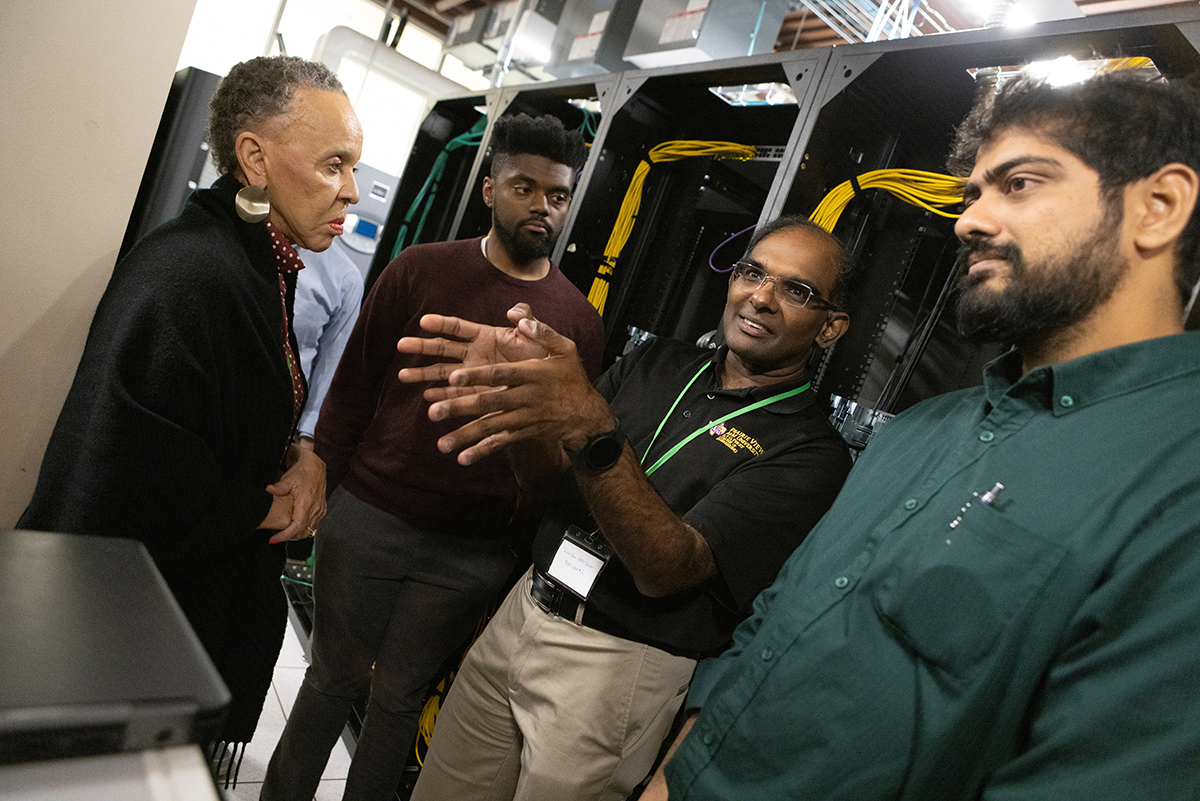 N. Joyce Payne, founder of the Thurgood Marshall College Fund, and Annamalai Annamalai, professor of electrical and computer engineering at Prairie View A&M University, second from right, tour the Center of Excellence Data Center with Srikanth Rangarajan, a Binghamton University research professor, right, and Braxton Perry, assistant director of diversity, equity and inclusion at Watson College.