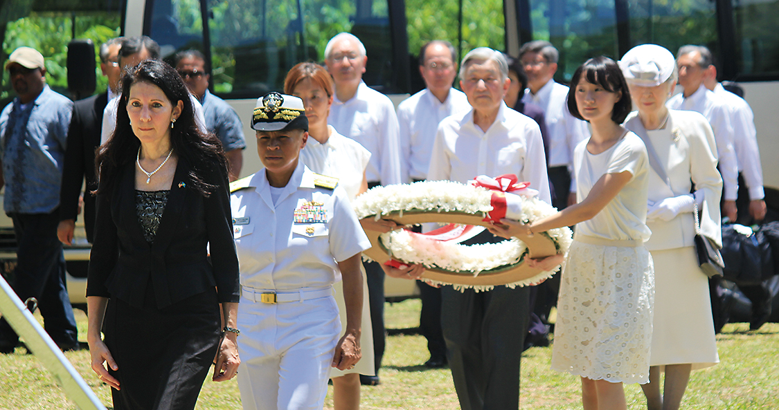 Left: Hyatt walks with Japanese Emperor Akihito before he lays a wreath at a
memorial site in Peleliu, Palau, where U.S. service members died in World War II.