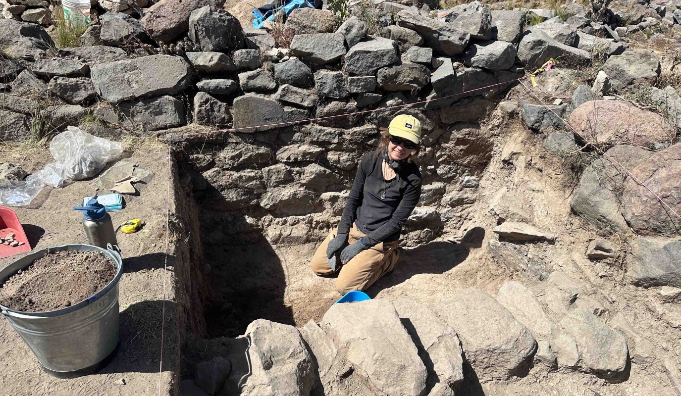 Anthropology major Sara Boudreaux near a buried stone wall she excavated near the town of Achoma in Peru.