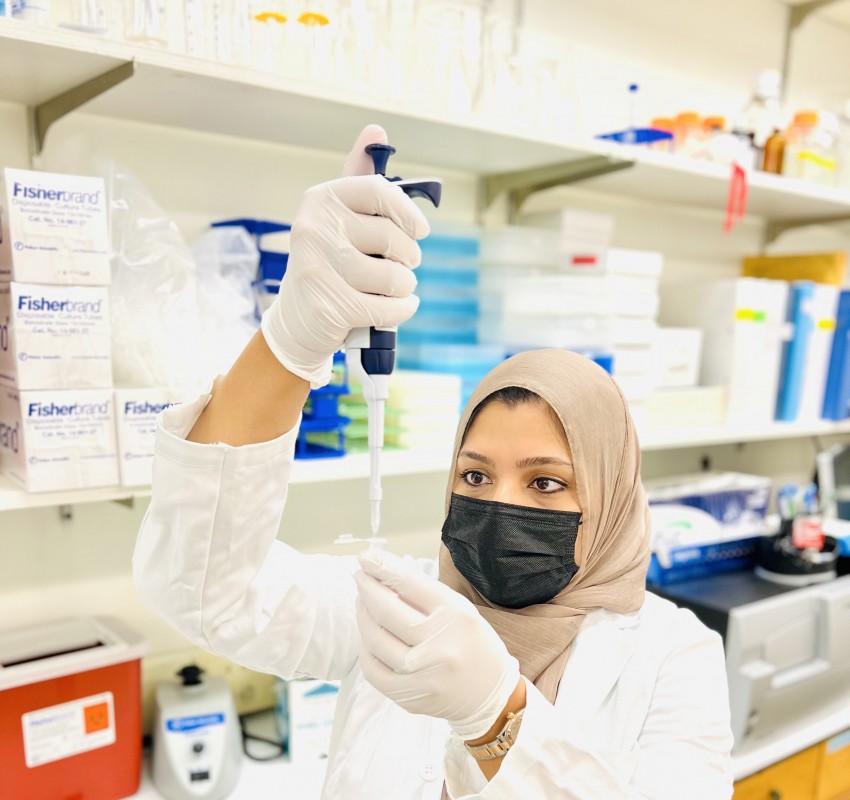 Risana Chowdhury, a doctoral candidate in anthropology, uses a micropipette to extract a specimen from a microcentrifuge tube.